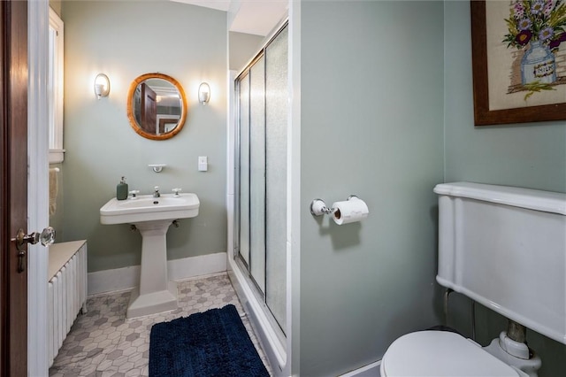 bathroom featuring an enclosed shower, tile patterned flooring, and toilet