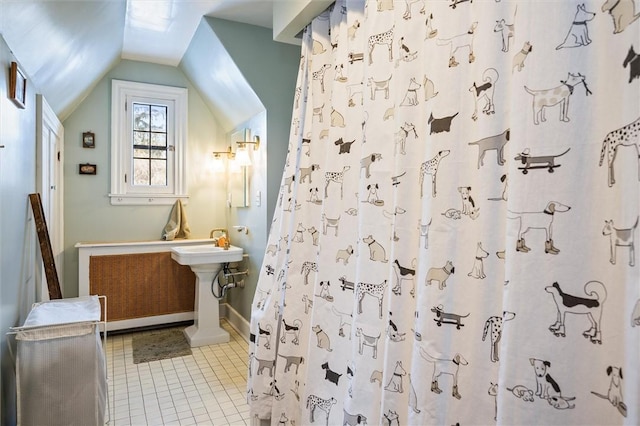 bathroom with tile patterned flooring, curtained shower, and vaulted ceiling