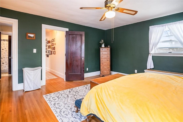 bedroom with hardwood / wood-style flooring and ceiling fan