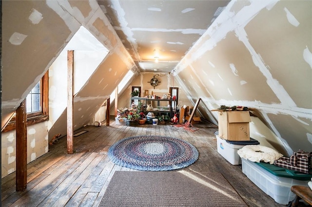 additional living space featuring lofted ceiling and wood-type flooring