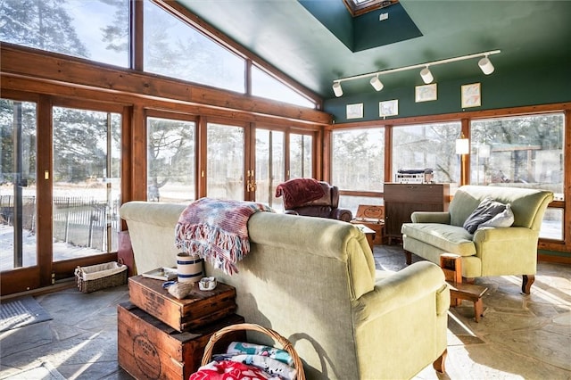 sunroom featuring vaulted ceiling with skylight