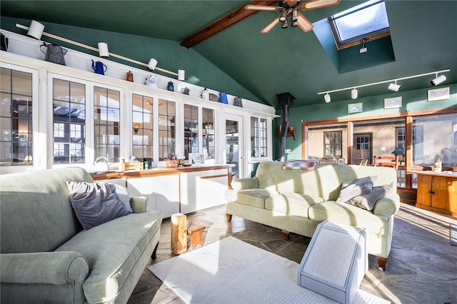 interior space featuring vaulted ceiling with skylight and ceiling fan