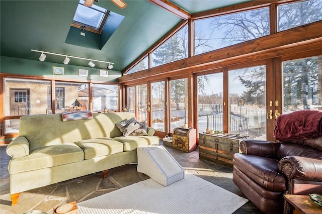 sunroom featuring vaulted ceiling with skylight