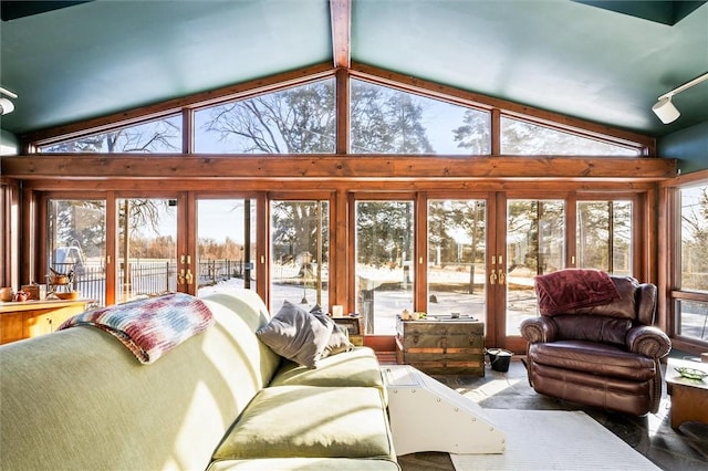 sunroom with vaulted ceiling, plenty of natural light, and french doors