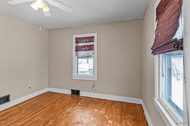 spare room with ceiling fan and hardwood / wood-style floors