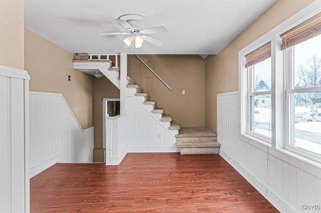 stairway featuring wood-type flooring and ceiling fan