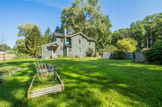 back of house with a lawn