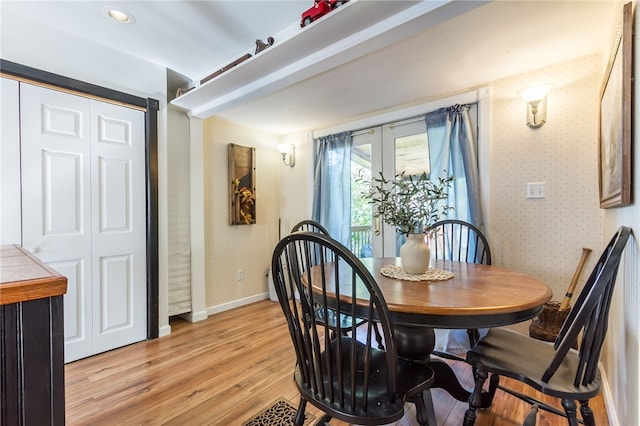 dining room featuring french doors and light wood-type flooring