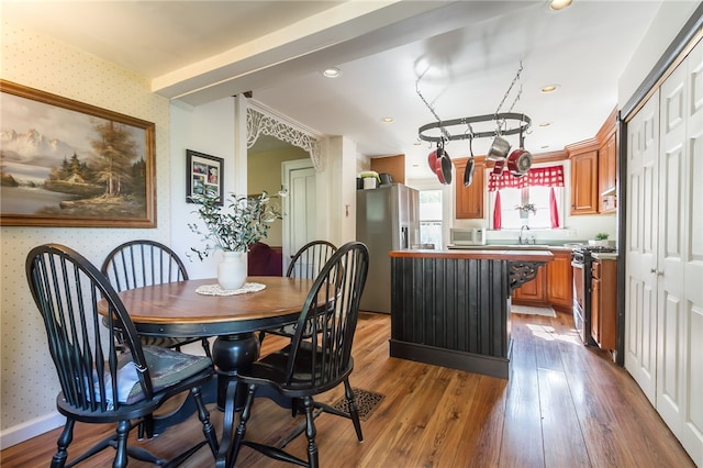 dining room featuring wood-type flooring and sink