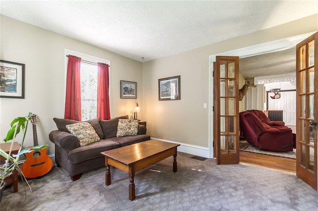 carpeted living room featuring french doors