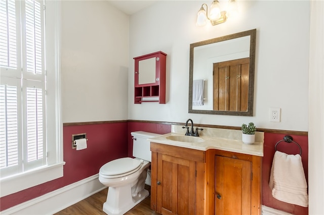 bathroom with vanity, hardwood / wood-style floors, and toilet