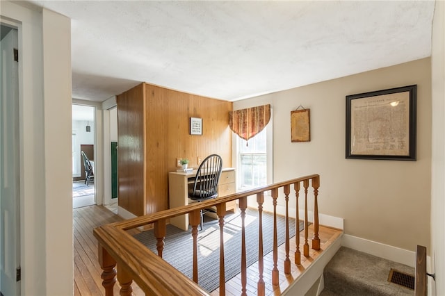 hallway with wood walls