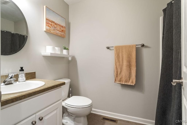 bathroom with vanity, tile patterned floors, toilet, and walk in shower