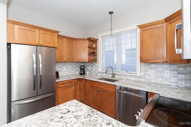 kitchen featuring sink, backsplash, stainless steel appliances, and hanging light fixtures