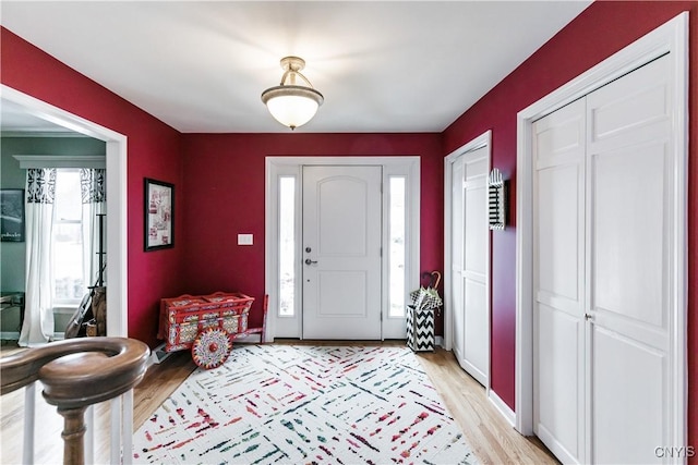 foyer entrance with plenty of natural light and light hardwood / wood-style flooring