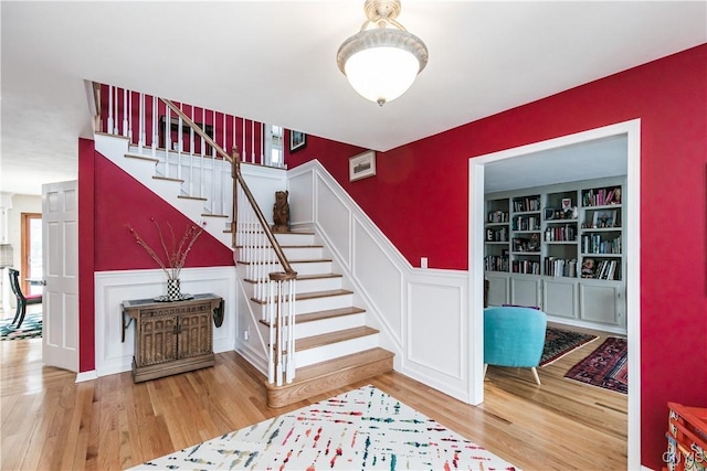 stairs featuring wood-type flooring and built in features