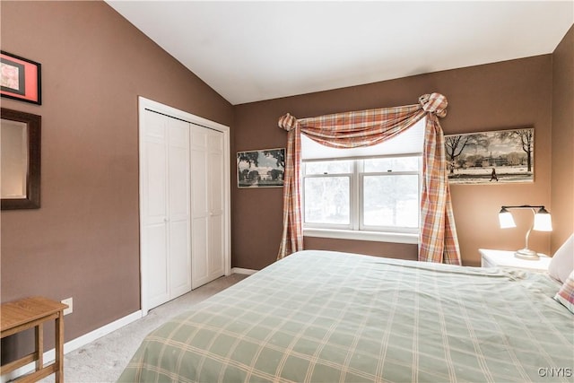 bedroom featuring vaulted ceiling, carpet flooring, and a closet