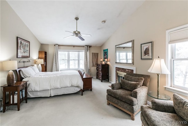 bedroom featuring multiple windows, lofted ceiling, and ceiling fan