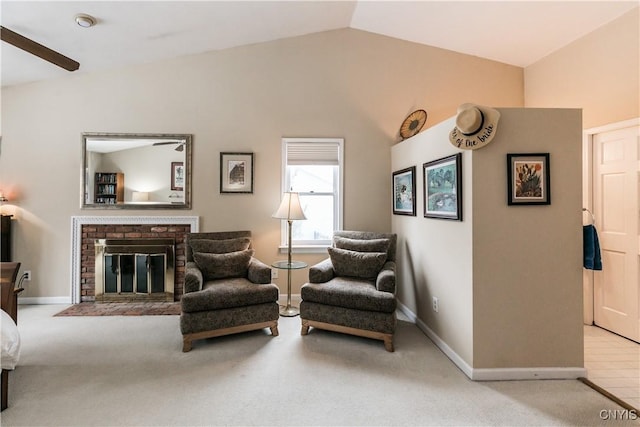 sitting room featuring lofted ceiling, light carpet, and a brick fireplace