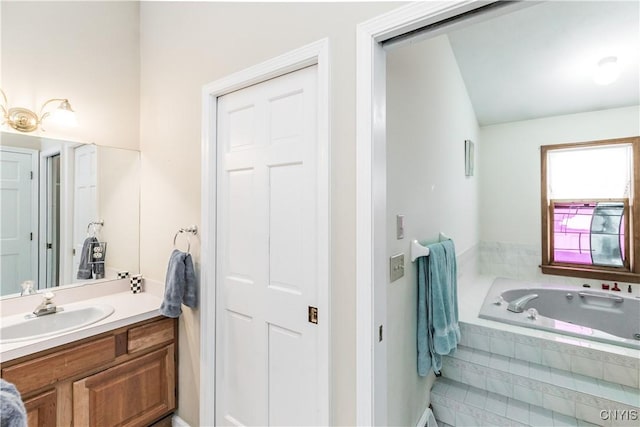 bathroom with a relaxing tiled tub and vanity