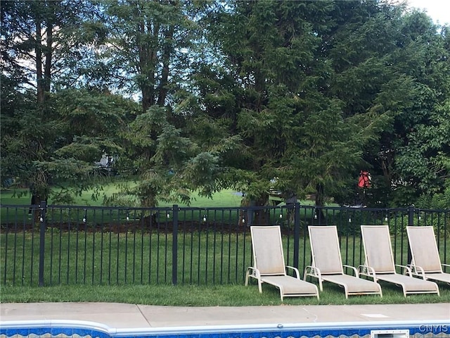 view of swimming pool featuring a yard