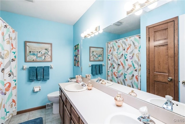 bathroom featuring a shower with curtain, vanity, tile patterned floors, and toilet