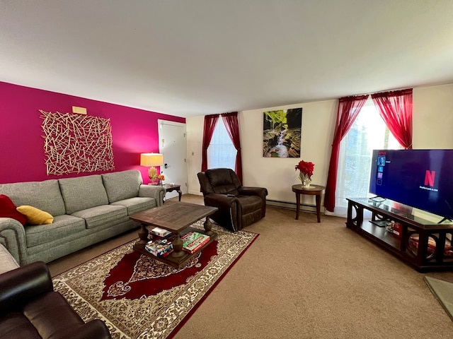 living room with a baseboard heating unit and carpet flooring