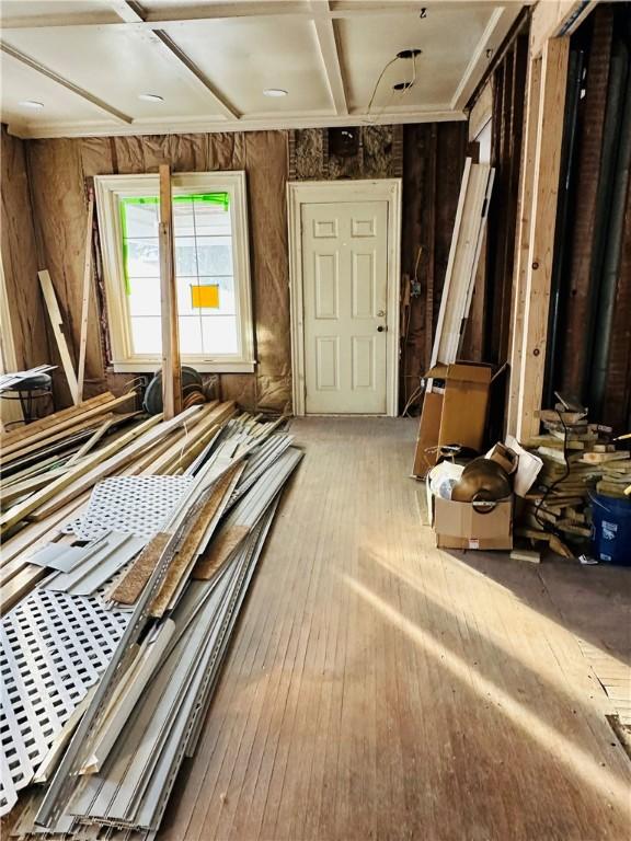 misc room featuring coffered ceiling and light hardwood / wood-style floors