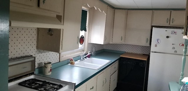 kitchen featuring tasteful backsplash, dishwasher, white fridge, and sink