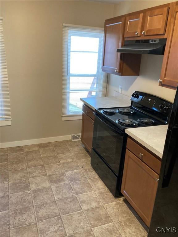 kitchen featuring black range with electric stovetop