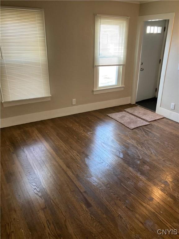 spare room with dark hardwood / wood-style floors