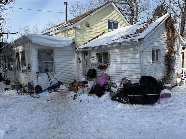 view of snow covered back of property