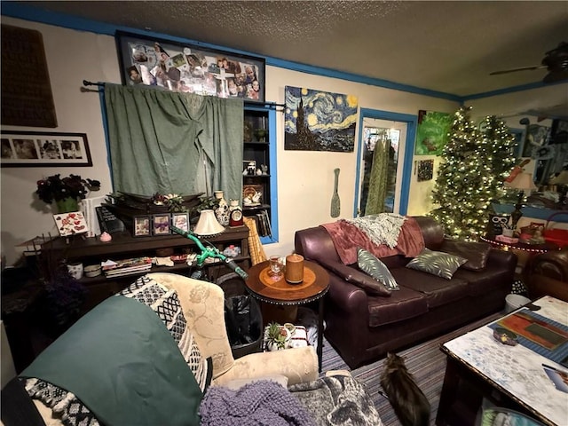 living room with ceiling fan and a textured ceiling