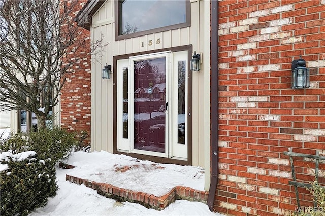 view of snow covered property entrance