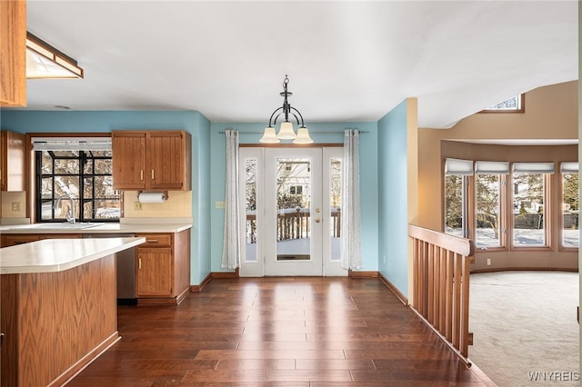 kitchen with sink, an inviting chandelier, dark hardwood / wood-style flooring, and decorative light fixtures