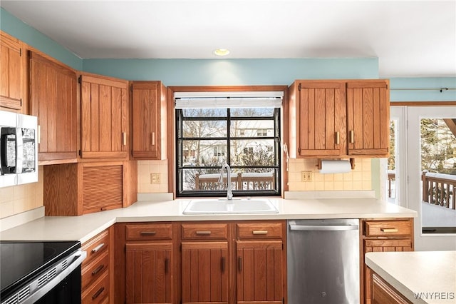 kitchen featuring appliances with stainless steel finishes, sink, decorative backsplash, and plenty of natural light