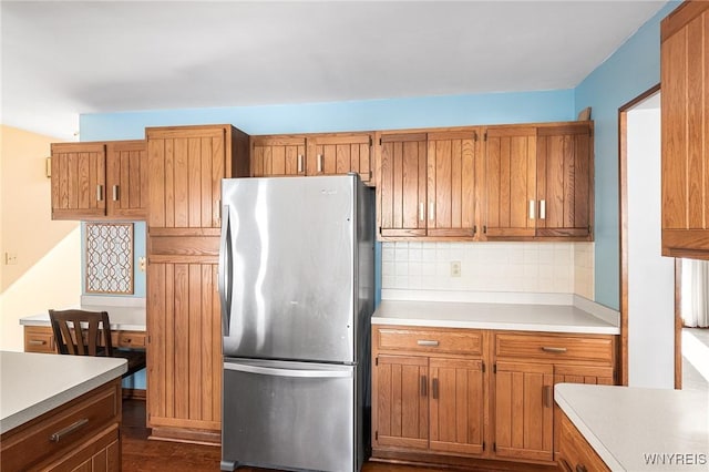 kitchen with stainless steel fridge and backsplash