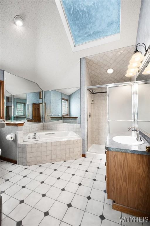 bathroom with lofted ceiling, plus walk in shower, vanity, and a textured ceiling