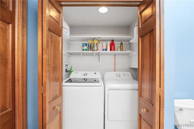 washroom with separate washer and dryer and a textured ceiling