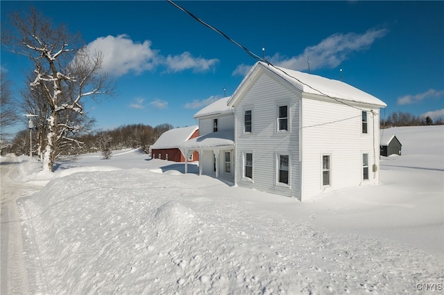 view of snow covered rear of property