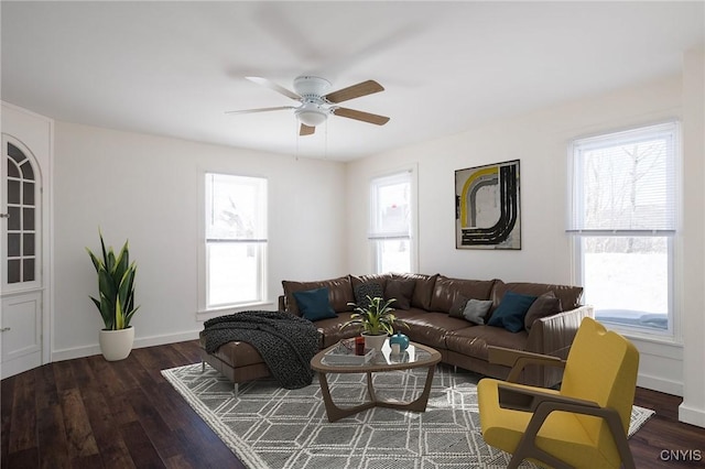 living room with dark hardwood / wood-style flooring, a wealth of natural light, and ceiling fan