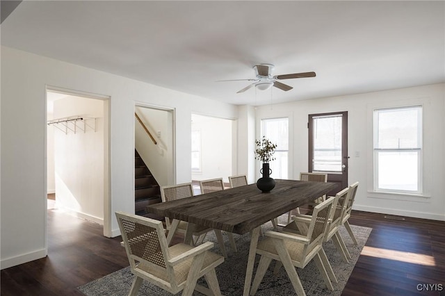 dining space with dark wood-type flooring and ceiling fan