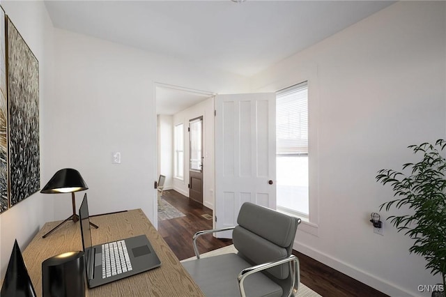 home office featuring wood finished floors, baseboards, and a wealth of natural light