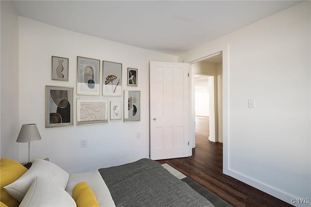 bedroom with dark wood-type flooring