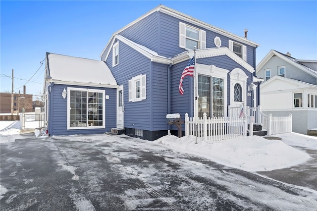 view of snow covered back of property