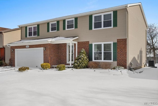 view of front of house with a garage and central AC