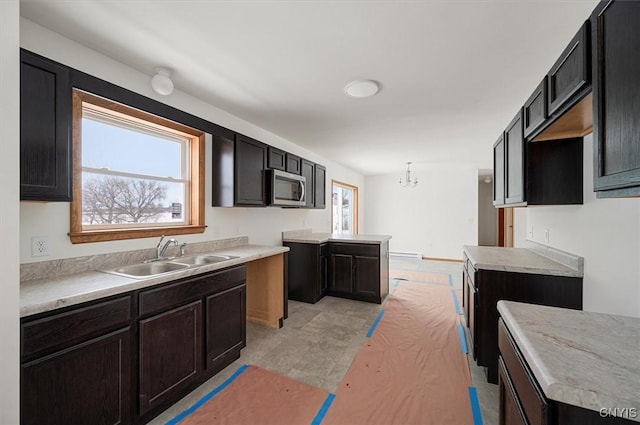 kitchen featuring sink, a chandelier, and decorative light fixtures