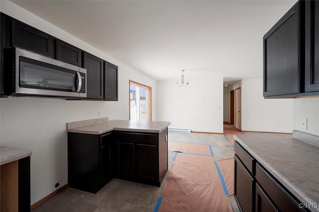 kitchen featuring baseboard heating, decorative light fixtures, and a chandelier