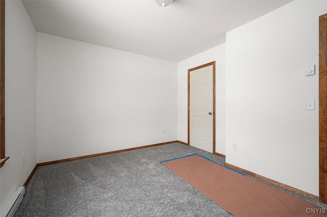 carpeted empty room with a baseboard radiator