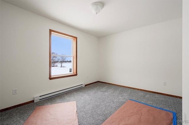 empty room featuring a baseboard radiator and carpet